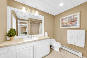 A large room currently used as a home gym and second office, already fitted with an egress window, sits beside the home's sixth full bath, offering the potential to convert the space into a sixth guest suite