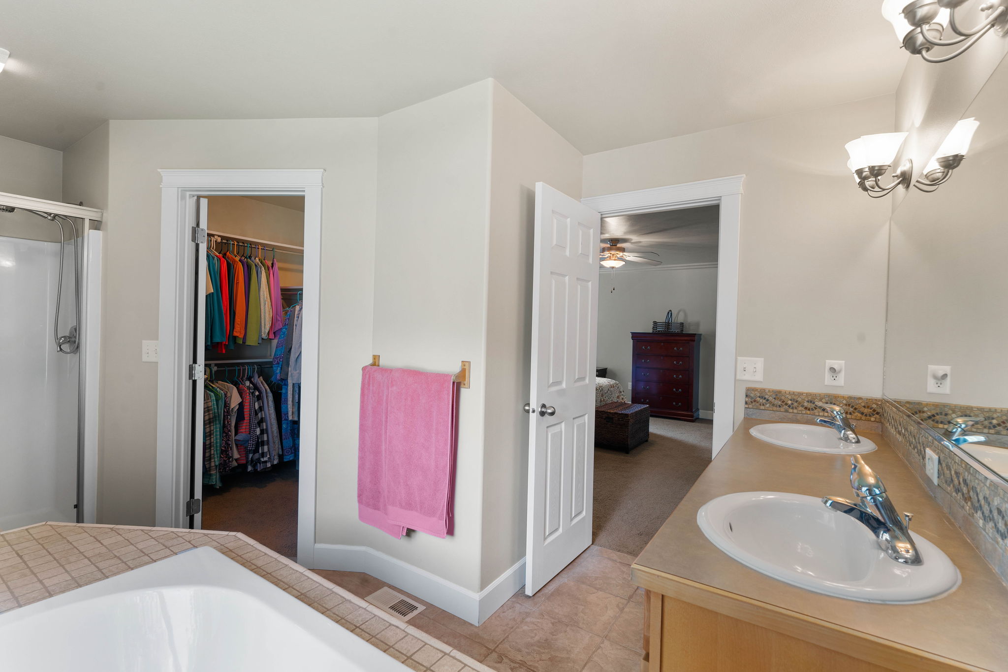 Primary Bathroom, featuring dual sinks, a garden tub and walk-in closet