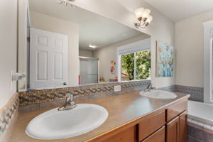 Primary Bathroom, featuring dual sinks, a garden tub and walk-in closet