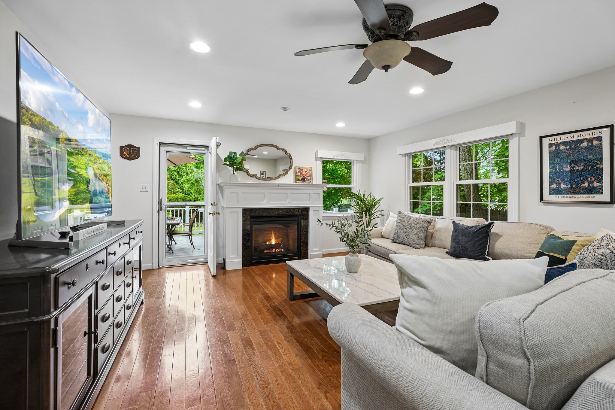 The center of it all. With windows on three sides, a gas fireplace, and easy connection to the kitchen and deck, this fabulous family room brings warmth, sunlight, and easy farmhouse-style living to the heart of the home.