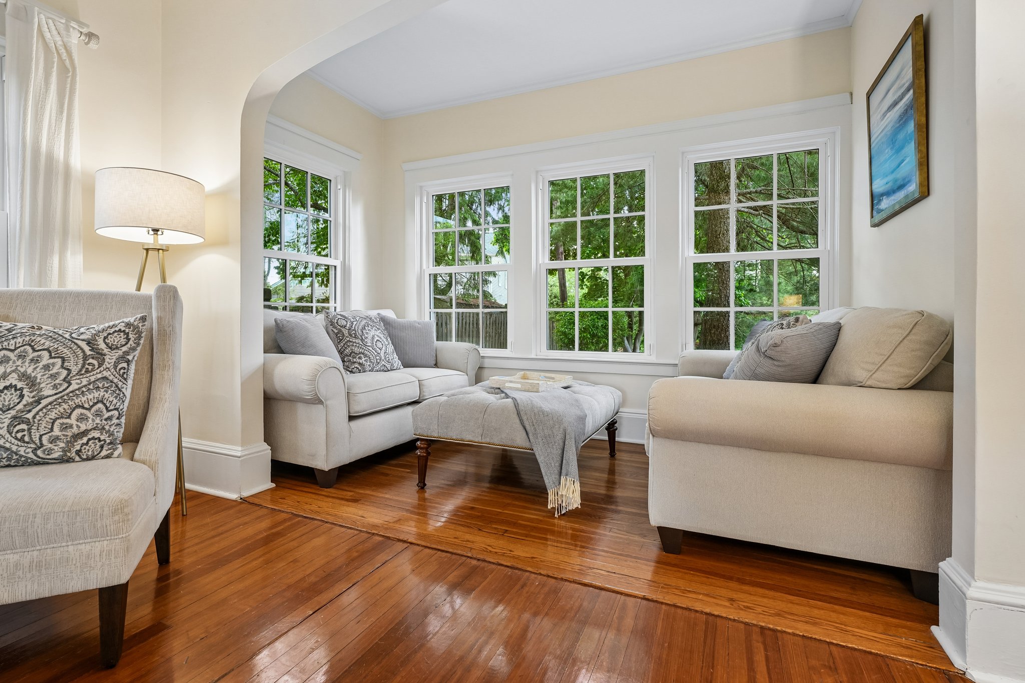 A sweet little sunroom moment just off the living room is wrapped in windows and overlooking the expansive property beyond. Morning coffee, afternoon reading, rainy-day conversations… this is the kind of space people quietly fall in love with.
