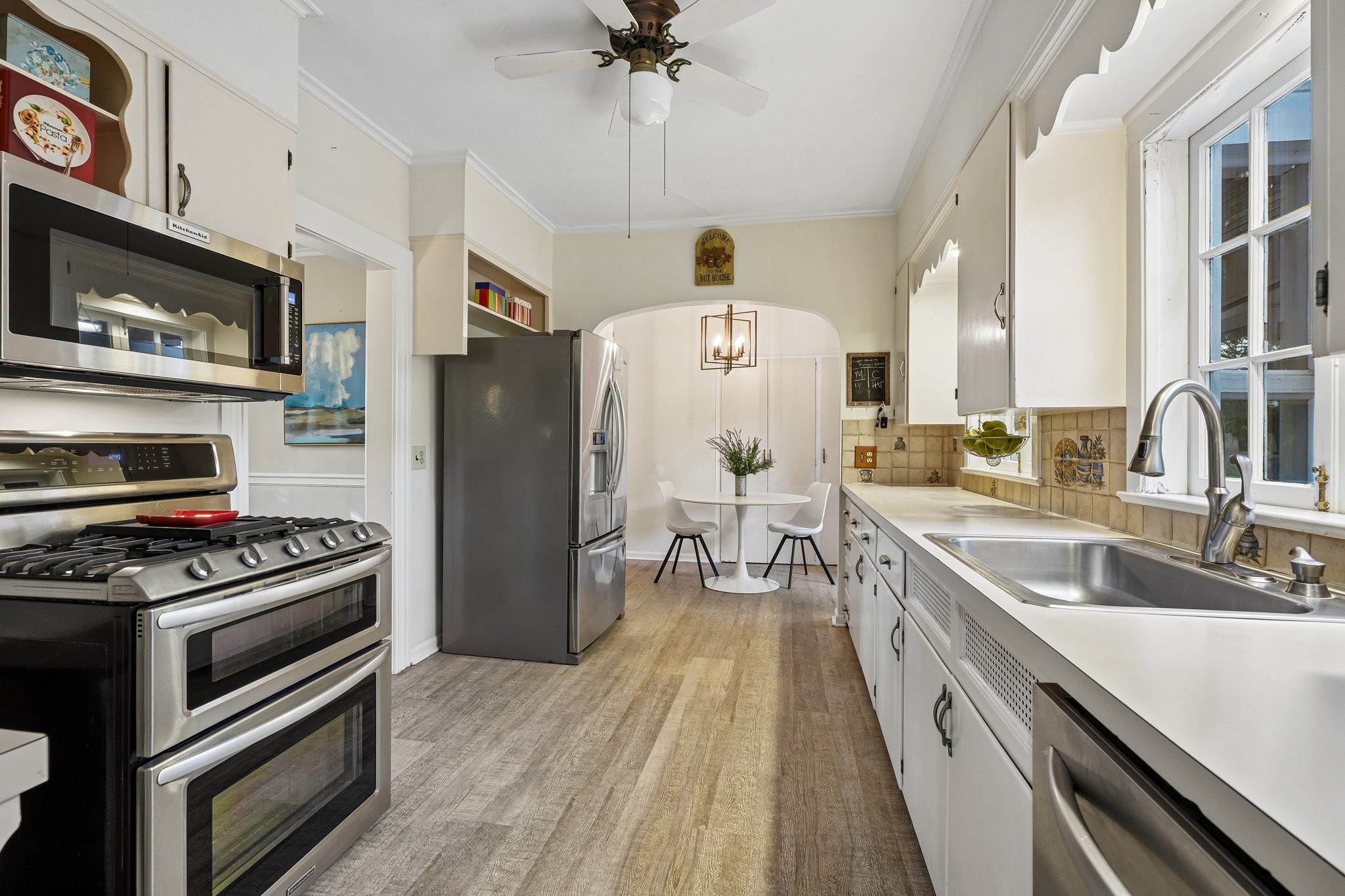 With peaceful backyard views, wonderful natural light, and easy connection to the family room and deck, this space is ready for its next chapter of memory-making, recipes, traditions, and laughter-filled evenings at home.