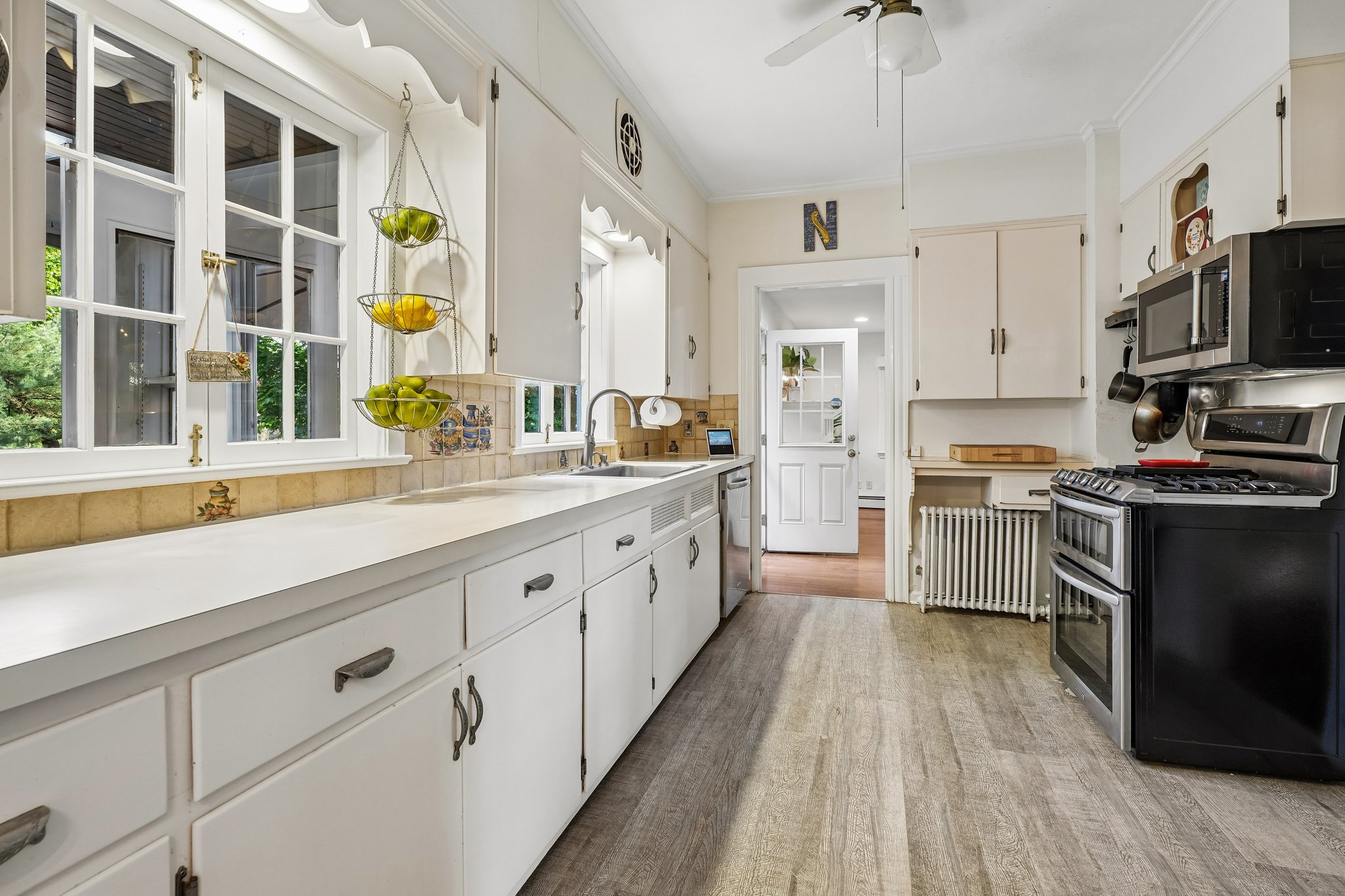 Wrapped in windows overlooking trees and the sprawling backyard, this kitchen has clearly been the backdrop for hundreds of pancake breakfasts, after-game pasta dinners, holiday baking marathons, and everyday conversations that stretched long past bedtime.