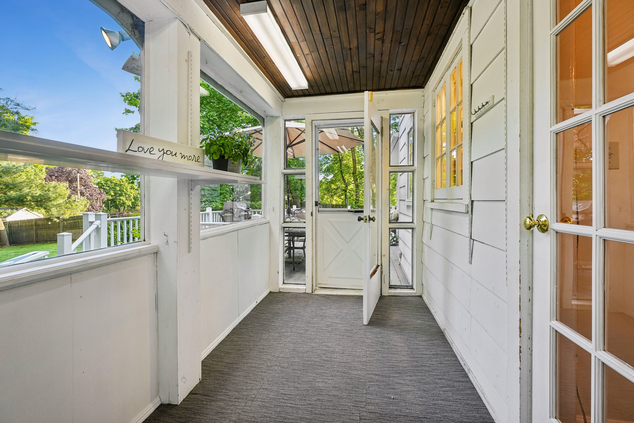 Part mudroom, part sunny garden retreat! This light-filled space wrapped in windows is the perfect landing spot for boots, backpacks, and muddy paws, while also doubling beautifully as a seedling haven for gardeners dreaming of tomato plants, herbs, and summer blooms long before planting season arrives.
