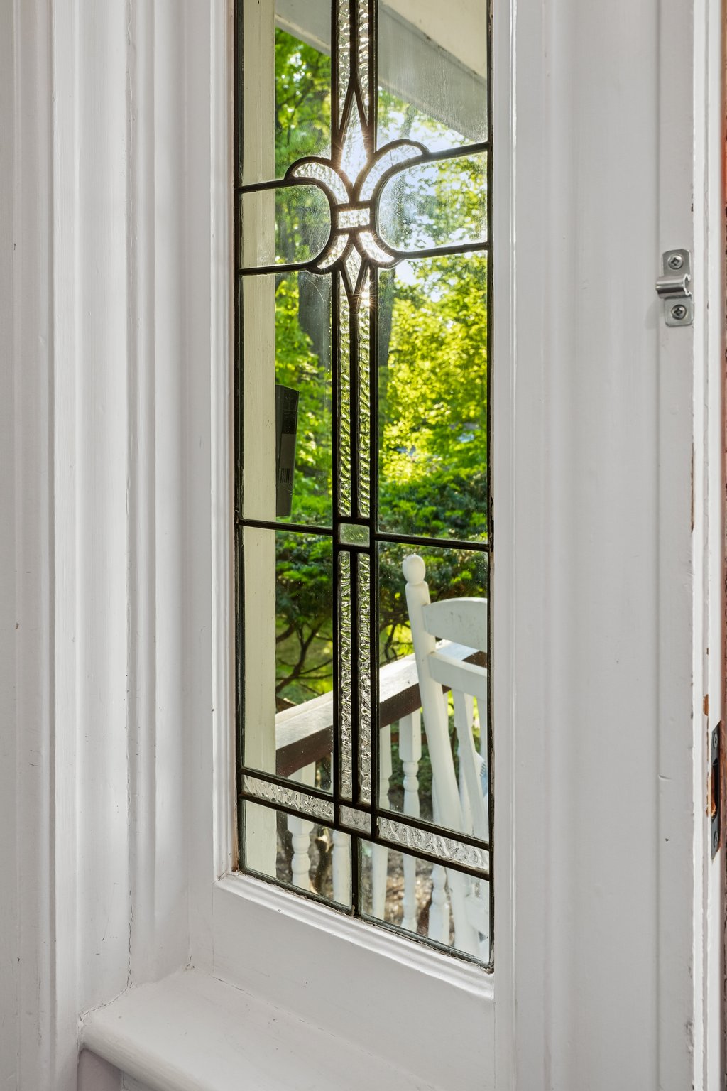 Handcrafted leaded glass, and sunlight filtering through the trees — a timeless welcome to this hilltop Caldwell classic.