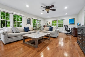 Windows on three sides, a glowing gas fireplace, and easy connection to the kitchen and deck make this family room the true center of everyday life.