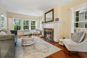 Wrapped in windows and leafy views, this inviting living room has a quiet, tucked-away feeling that makes it hard to believe Manhattan is only about 20 miles away. More retreat than suburb, it’s a space that invites deep breaths, slow mornings, and evenings by the fire as the trees sway just beyond the glass.