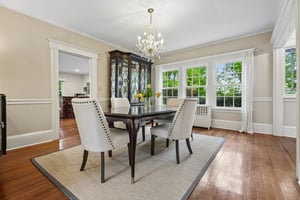 The formal dining room captures beautiful western light and seasonal sunset views stretching toward the Watchung Mountains.