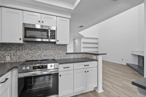 Newly updated with new white shaker cabinets and hardware, new appliances, sink & faucet, gray quartz countertops and backsplash.