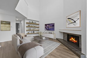 Built-in bookshelves, fireplace, soaring ceiling, natural light