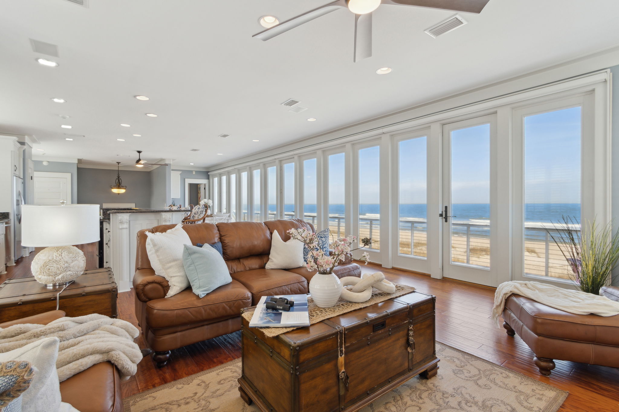 The main living area on the third floor showcases a breathtaking wall of floor-to-ceiling glass doors ...