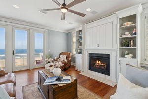 Elegant details abound, with custom millwork, cherry-hued wood flooring, plantation shutters, and a cozy gas fireplace creating a refined yet inviting ambiance.