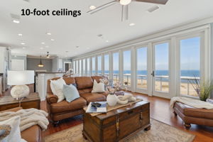 The main living area on the third floor showcases a breathtaking wall of floor-to-ceiling glass doors ...