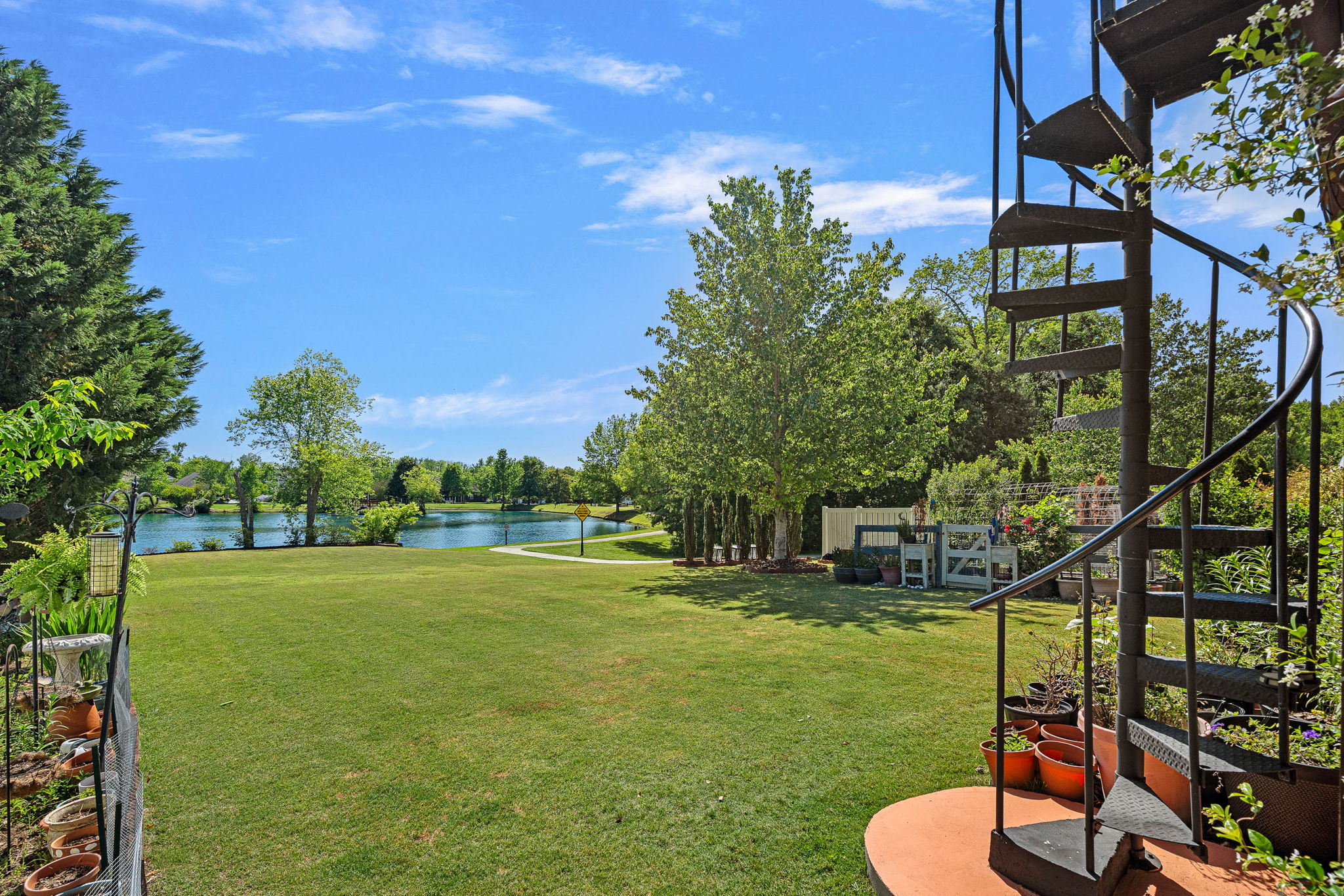 Spiral Staircase from Balcony to Covered Patio/Pond View