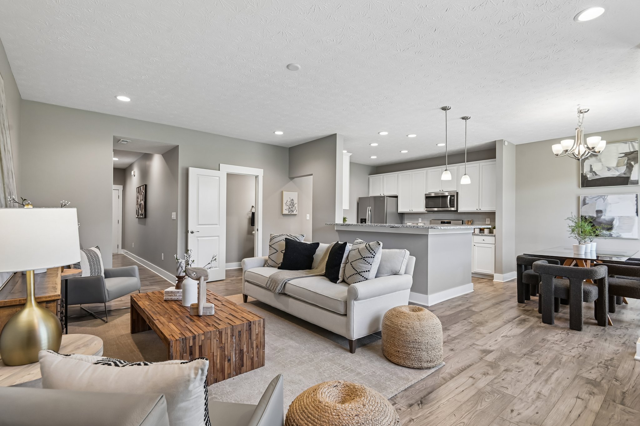 Open sightlines seamlessly connect the living room, dining area, and kitchen..