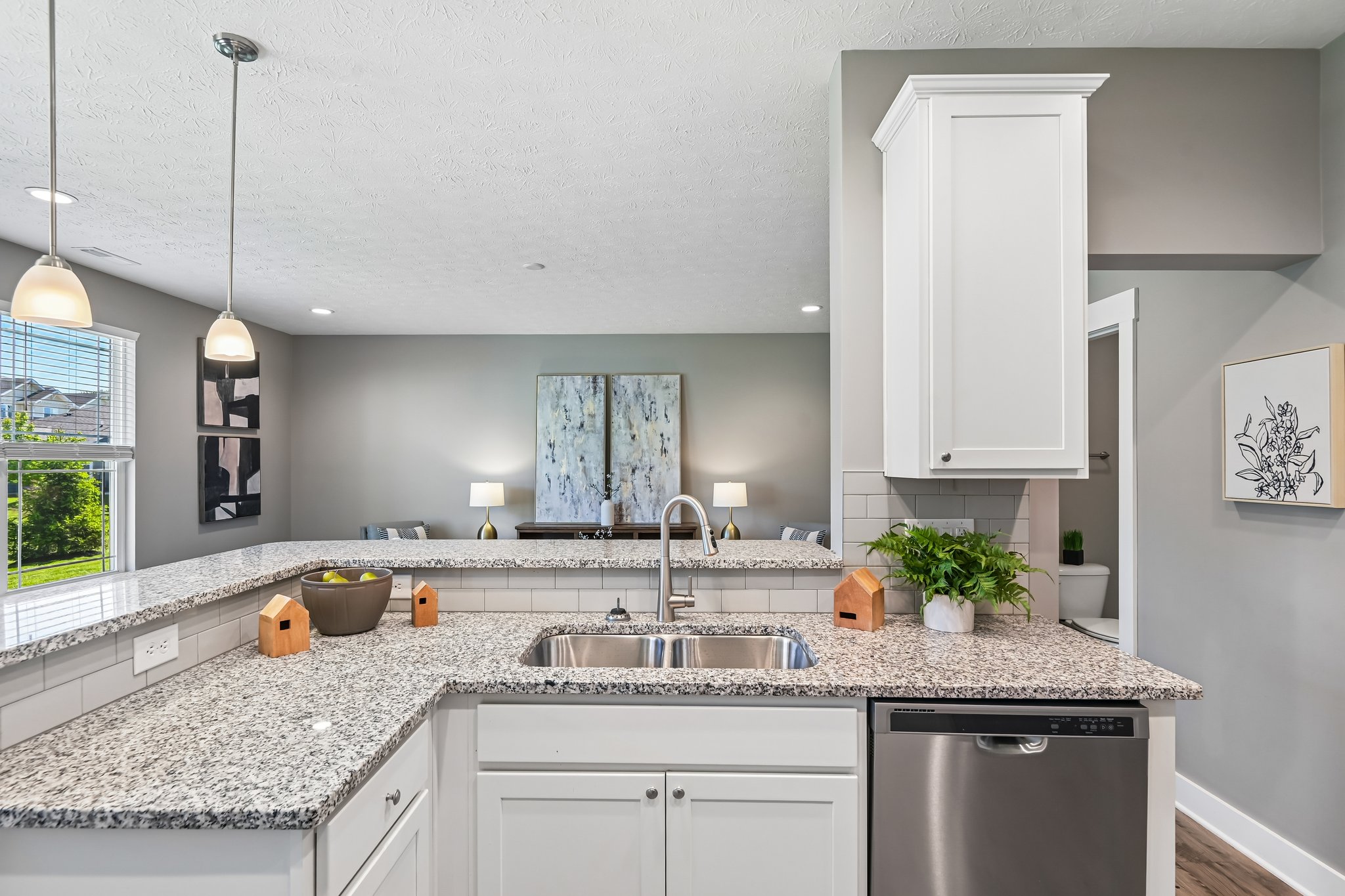 Kitchen sink overlooks the living area, creating a connected and open feel.