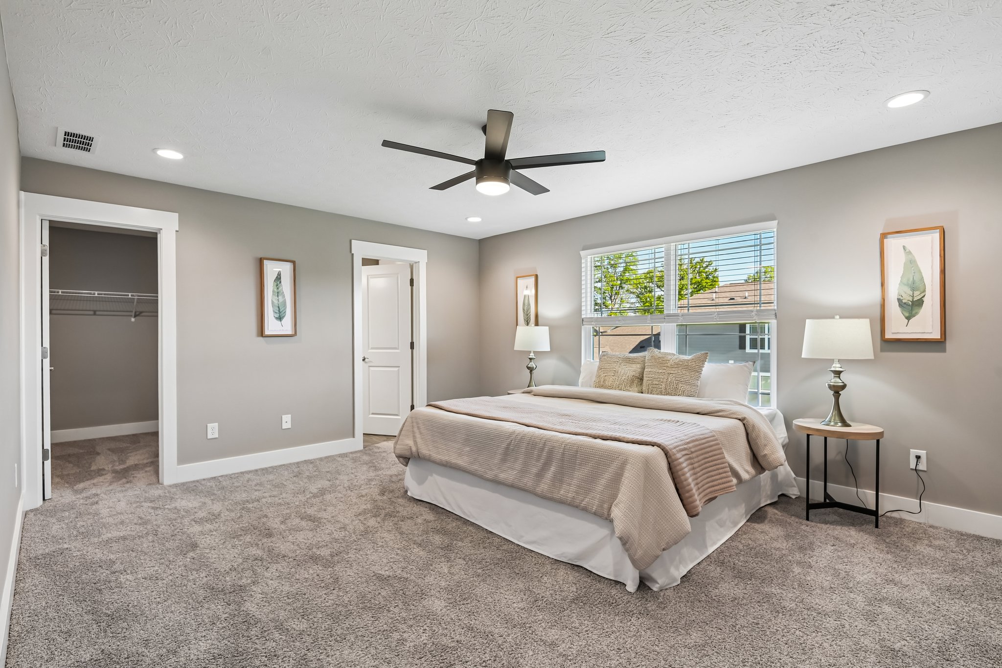 Generously sized primary suite with calming tones and excellent natural light