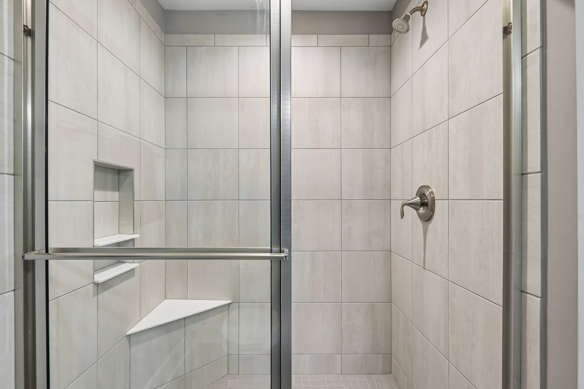 Large walk-in tiled shower adds a luxury touch to the owner’s bath.