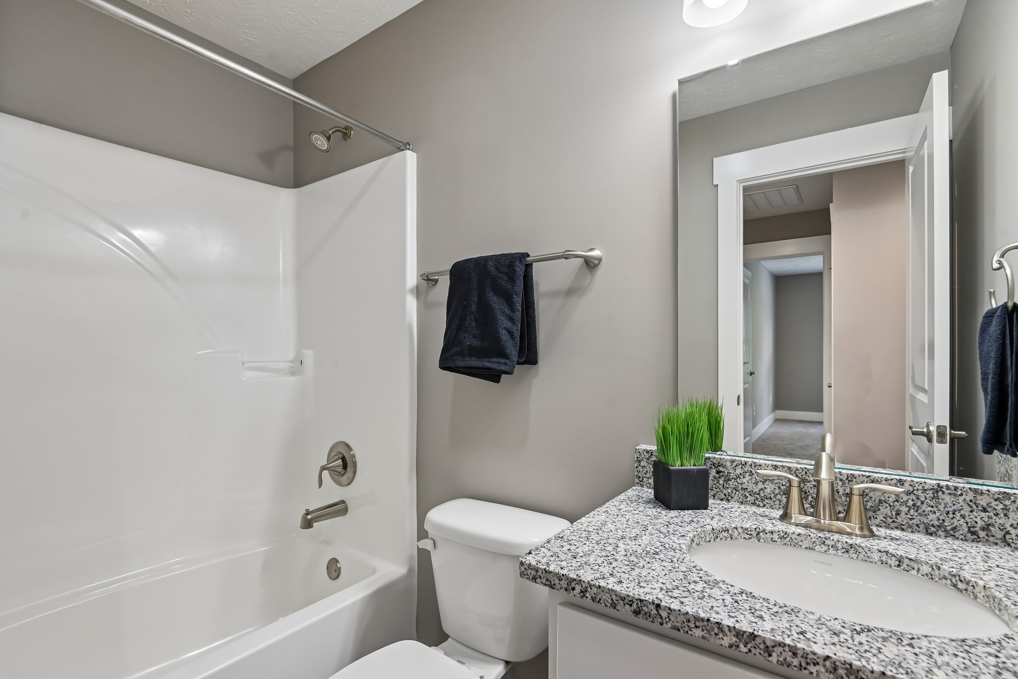 Bright secondary bath with clean finishes and neutral design.