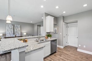 Spacious wraparound kitchen bar offers abundant prep space, seating, and an open-concept design ideal for entertaining