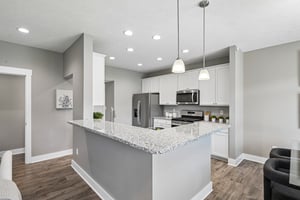 Beautiful kitchen featuring white cabinetry, granite-style counters, and modern finishes.