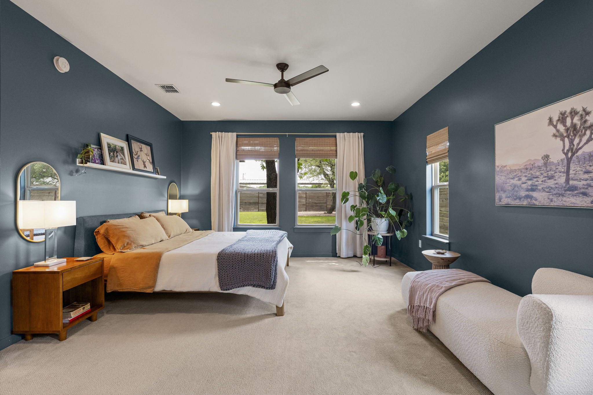 With ample space beyond the sleeping area, the primary bedroom easily accommodates a cozy reading nook or quiet retreat.