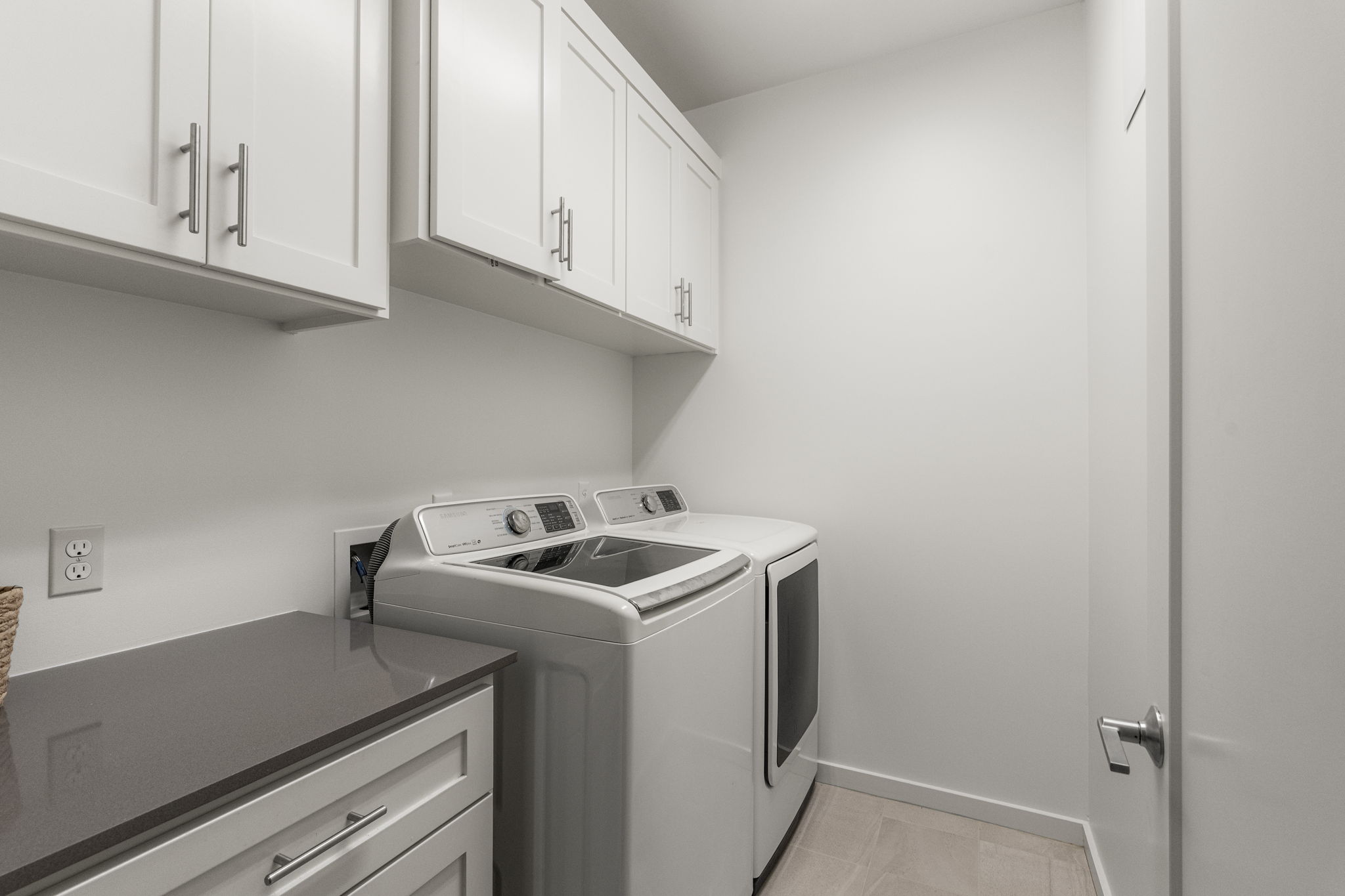 Dedicated laundry room with additional storage and everyday functionality.