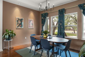 Large windows frame peaceful views of the surrounding oak trees, creating an inviting setting for shared meals.