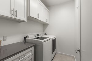 Dedicated laundry room with additional storage and everyday functionality.
