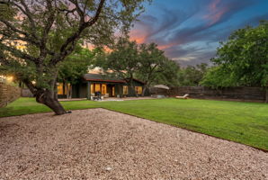 As the sun sets over the Texas Hill Country, the backyard transforms into a private oasis beneath the glow of the evening sky