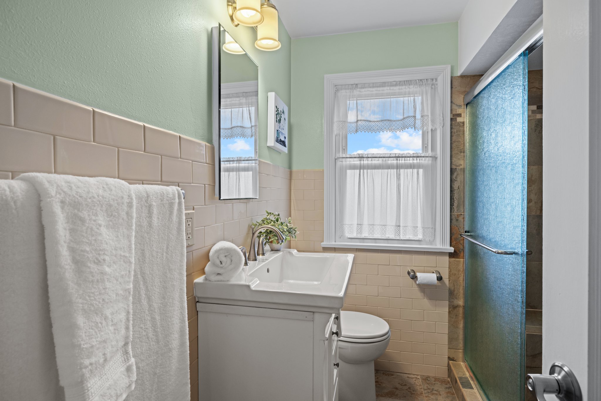 The main bath has been updated with a beautiful walk in shower and shower seat