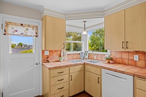 Love the corner window and sink overlooking your backyard sanctuary