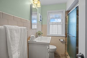 The main bath has been updated with a beautiful walk in shower and shower seat