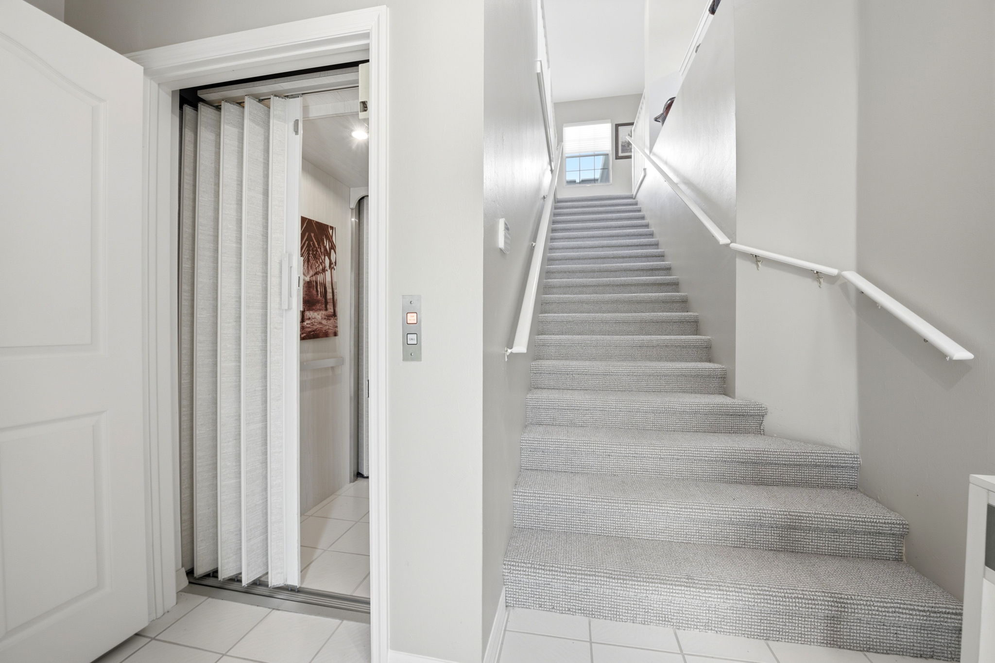 Foyer with a private elevator and stairs
