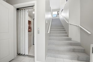 Foyer with a private elevator and stairs