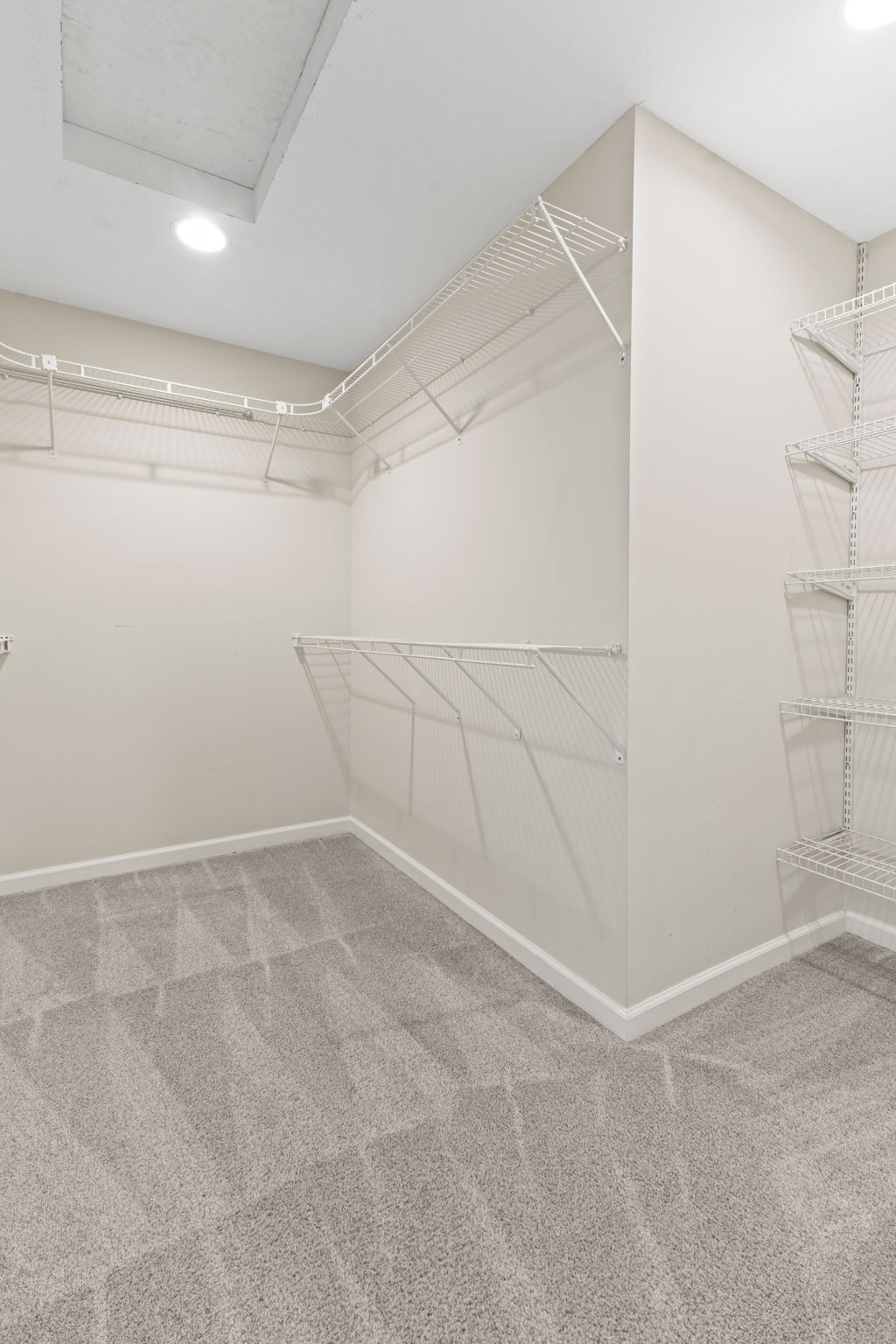 1 of 2 primary bedroom closets