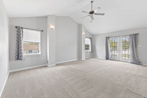 Primary bedroom with balcony access