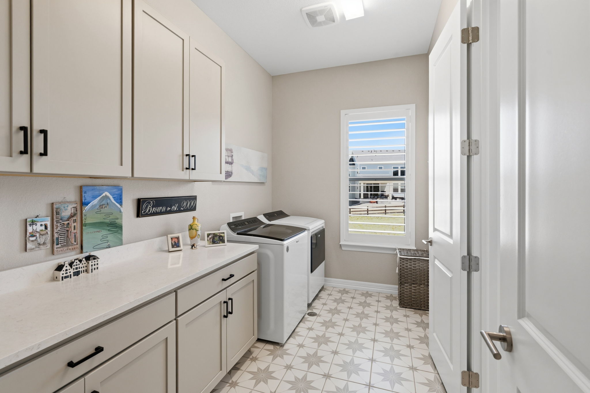Large laundry room with private access to primary bath