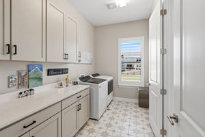 Large laundry room with private access to primary bath