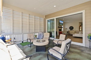 Expansive multi panel stacking sliding door from family room to large covered patio