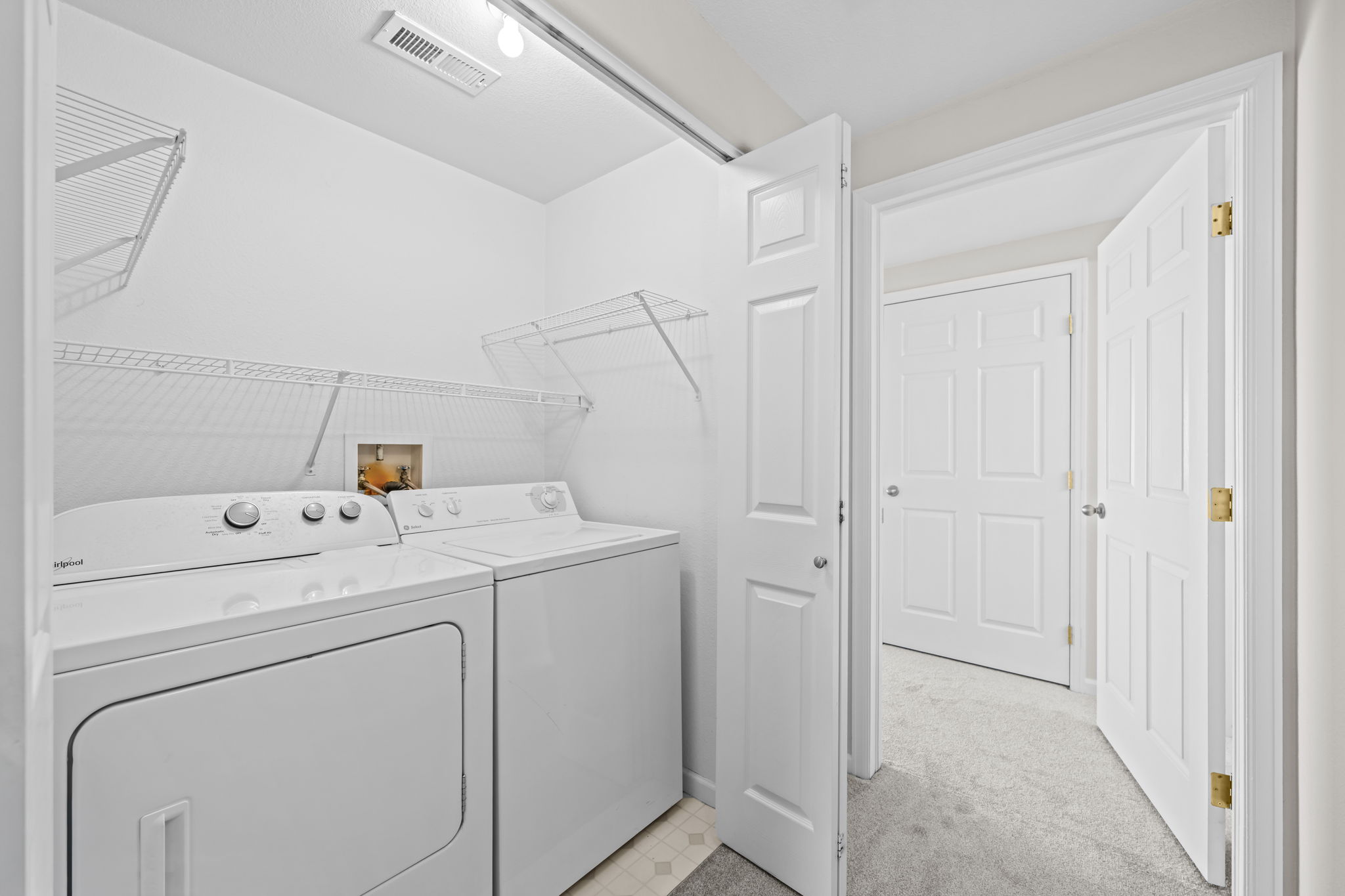 Washer & Dryer conveniently located between bedrooms.