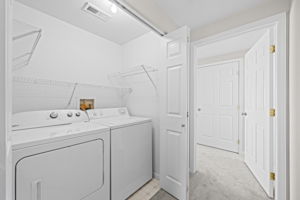 Washer & Dryer conveniently located between bedrooms.