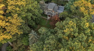 Adjoining township-owned wooded land gives this cul-de-sac setting a lovely sense of openness, with seasonal color woven into the view.