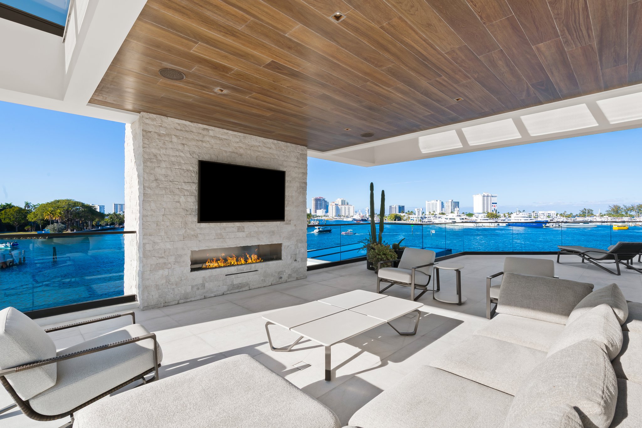 Sky lounge with stone fireplace and panoramic Intracoastal views at 84 Isla Bahia