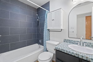 Bathroom 2 renovated with glass tile counter.
