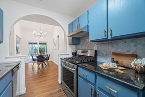 Renovation includes marble hex tile backsplash, new counterrops, beautiful blue cabinetry and a suite of stainless-look appliances