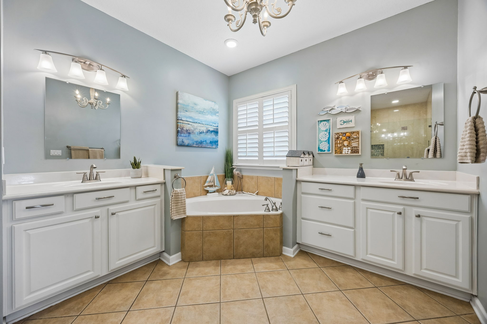 Primary bathroom features dual vanities.