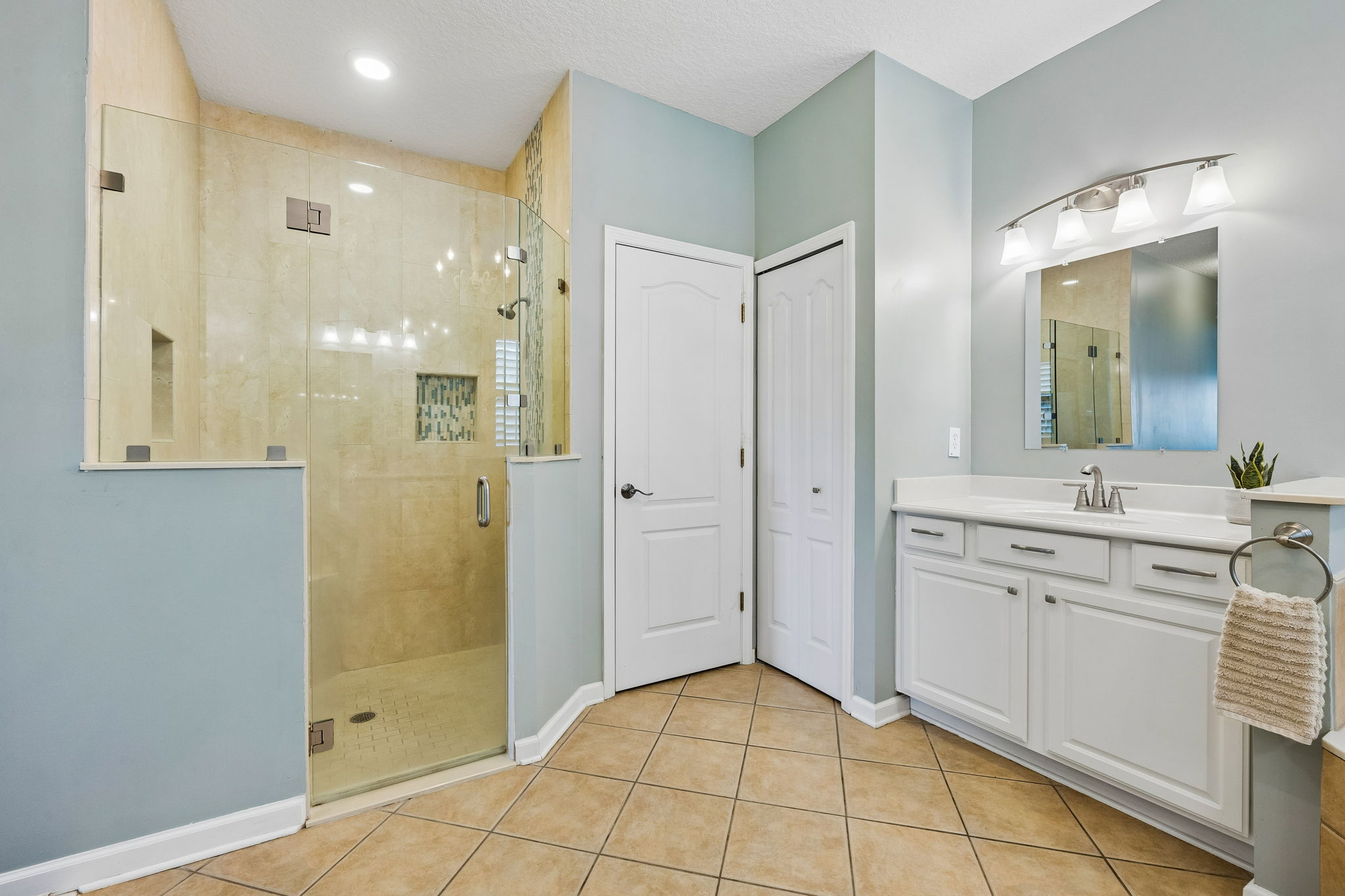 Walk in tiled shower.