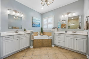 Primary bathroom features dual vanities.