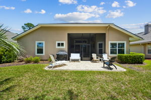 Rear exterior of the home showcasing a well maintained backyard setting.